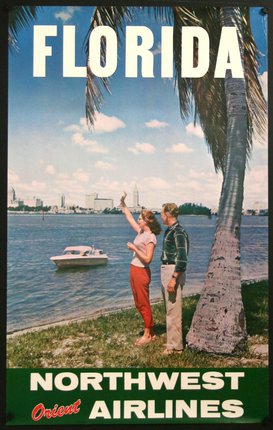 a man and woman standing next to a tree and a boat