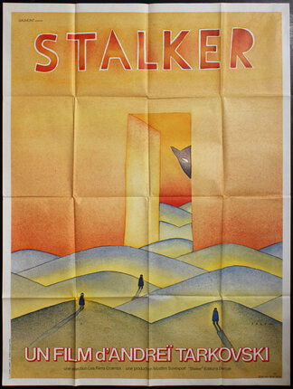 a pastel drawing of a large cat peeking through a doorway at three people walking in sand dunes 