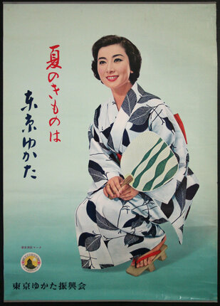 a woman in a kimono holding a fan
