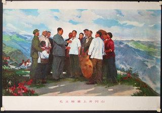 a group of people standing on a mountain