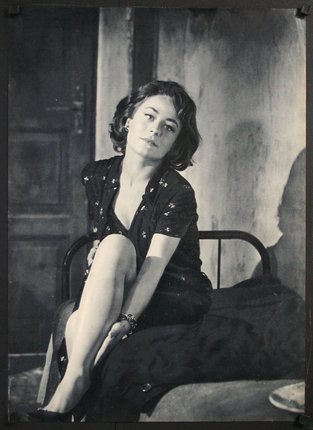 a woman sitting on a bed