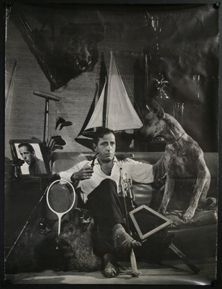 a man sitting on a couch with a dog and a mirror