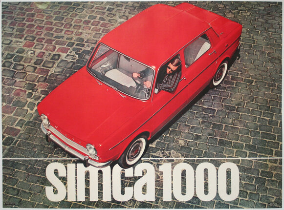 a red car with a man in the driver's seat