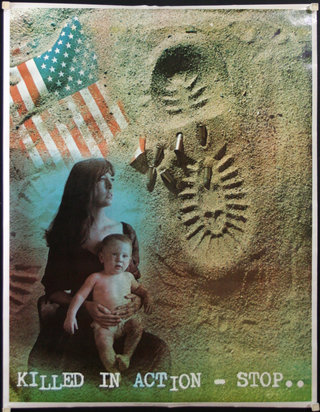 a woman holding a baby in sand
