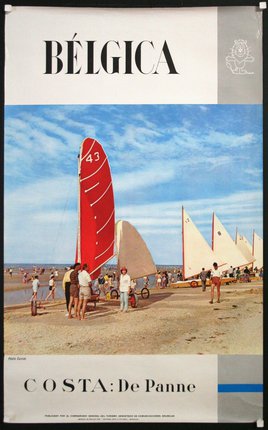 a group of people on a beach with sailboats