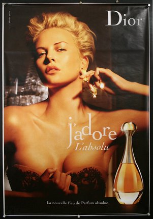 a poster of a woman with a bottle of perfume