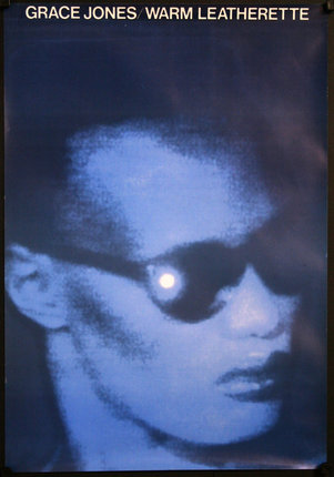a man wearing sunglasses and a light in the dark