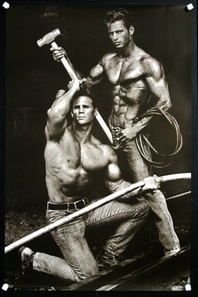 a black and white photo of men holding an axe