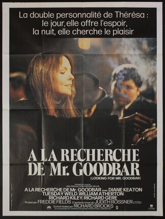 a movie poster with actress Diane Keaton smoking in a crowded bar