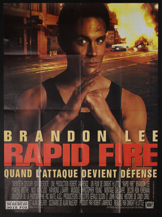 movie poster of a man pressing his fist against his other open hand and an explosion behind him