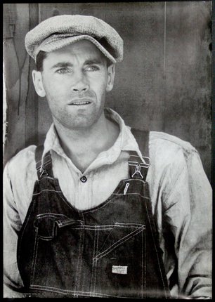 a man wearing overalls and a hat