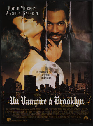 Movie poster of Eddie Murphy as a vampire ravaging Angela Bassett with the city skyline below.
