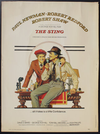 a poster of two men in hats sitting on a desk