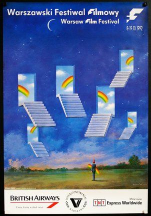 a man standing in a field with stairs and rainbows