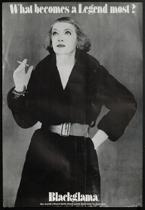 a woman in a black coat holding a cigarette