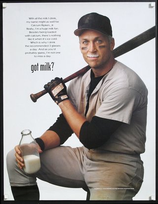 a man holding a baseball bat and a bottle of milk