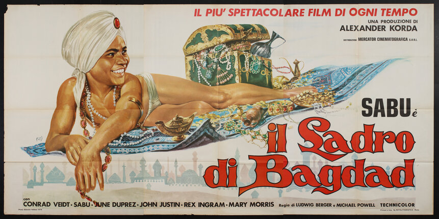 movie poster with of a boy in a turban lying on a magic carpet with a chest of treasures.