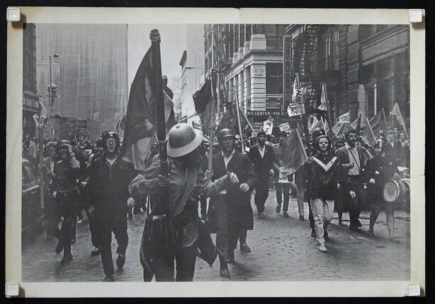 a group of people marching in a street