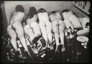 a group of naked people lying on a bed