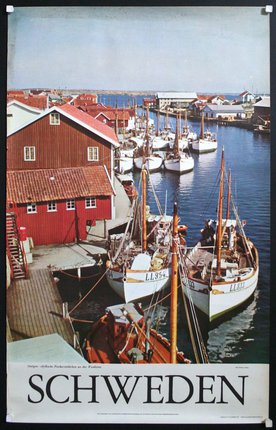 boats in a harbor with a dock and buildings