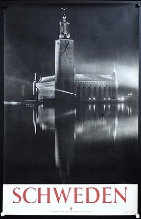 a building with a clock tower and a tower on the water