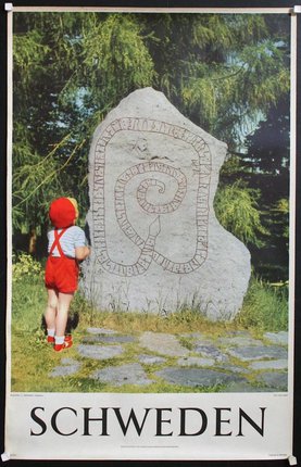 a child standing next to a stone