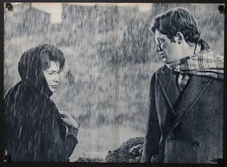 a man and woman standing in the rain