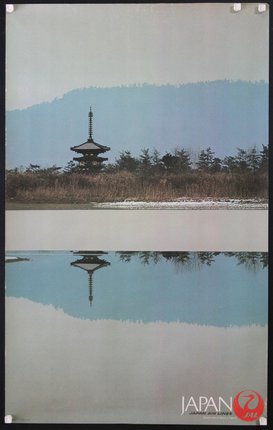 a reflection of a pagoda in water
