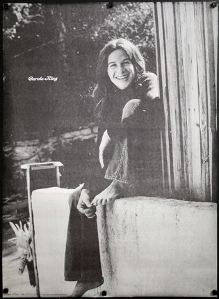 a woman leaning against a wall smiling