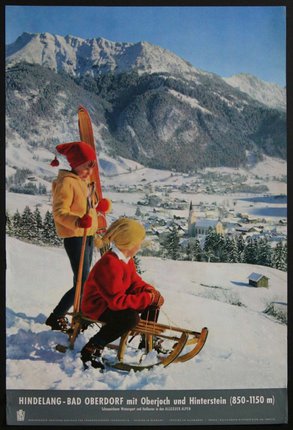 a couple of children on a sled in the snow