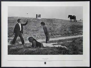 a man pointing at a woman lying on the ground