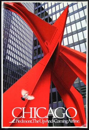 a red sculpture in front of a building