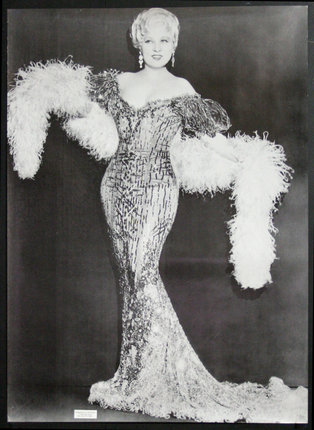 a woman in a dress with a feather boa