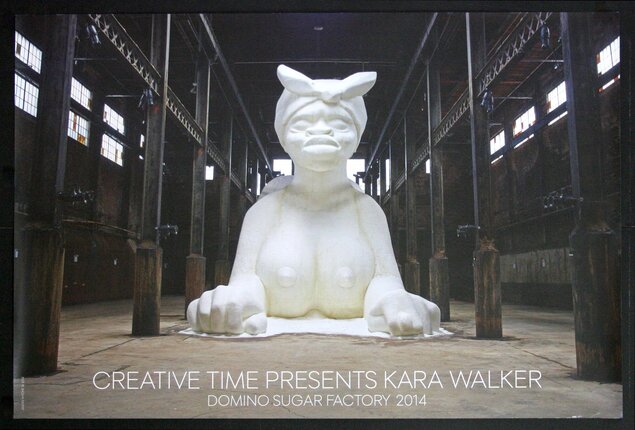 a large white statue in a warehouse