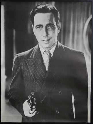 a man in a suit holding a gun