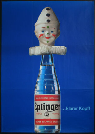 a bottle with a doll head on it