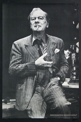 a man in a suit smoking a cigarette