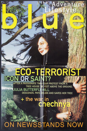 a magazine cover with a woman leaning against a tree