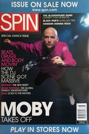 a magazine cover with a man in a pink shirt and black pants