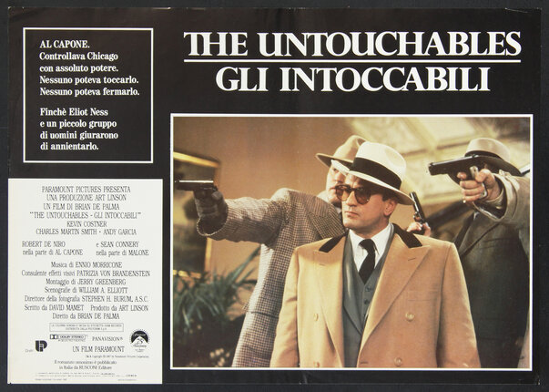 a poster of a movie with a group of men holding guns