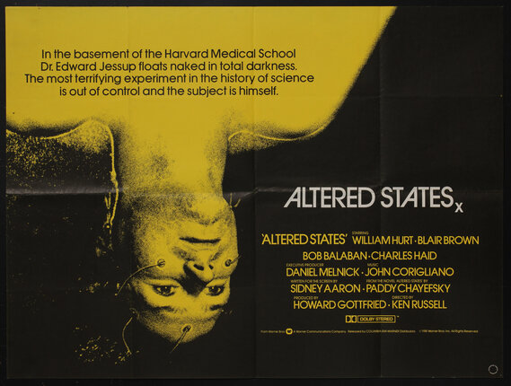 a movie poster with a man lying upside-down with electrodes stuck to his face