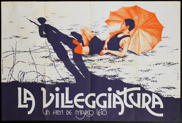 a poster of a man lying on the ground with an umbrella