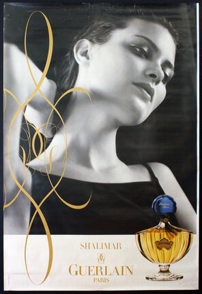 a poster of a woman with a bottle of perfume
