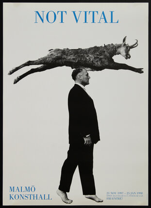 a man in a suit with a goat on his head