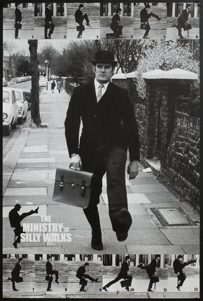 a man in a suit running on a sidewalk