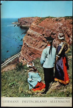 a group of people looking at a cliff