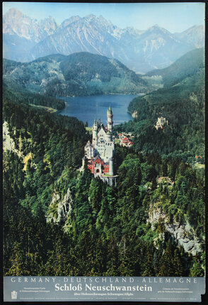 a castle on a hill surrounded by trees and a lake