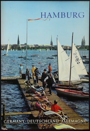 a group of people on a dock with sailboats