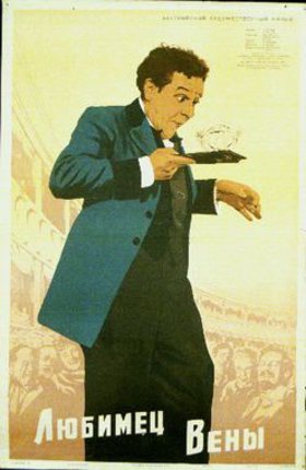 a man in a blue suit pointing at a diamond
