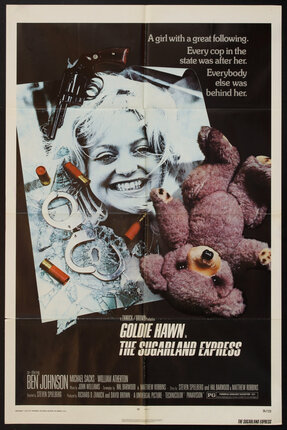 a movie poster of a woman with a teddy bear and handcuffs